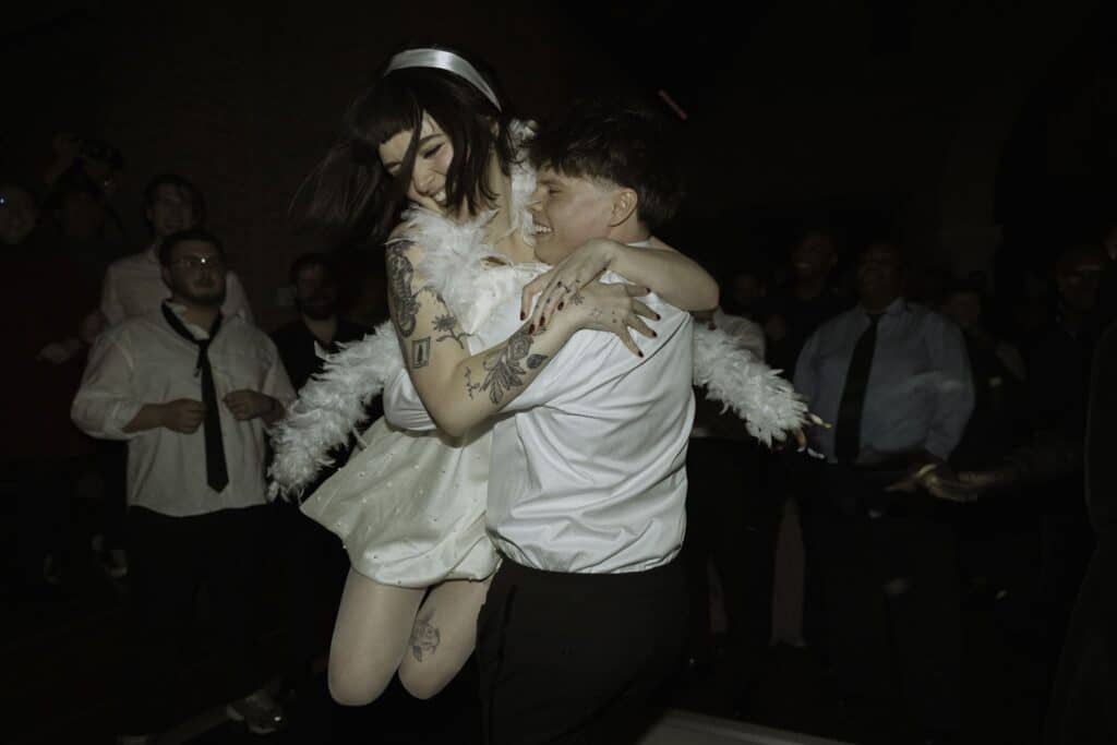 A groom spins his bride during their dance