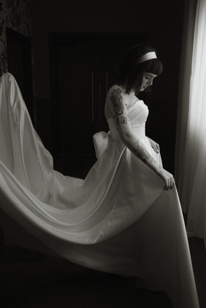 Moody editorial-style wedding portrait  of the bride with dramatic light