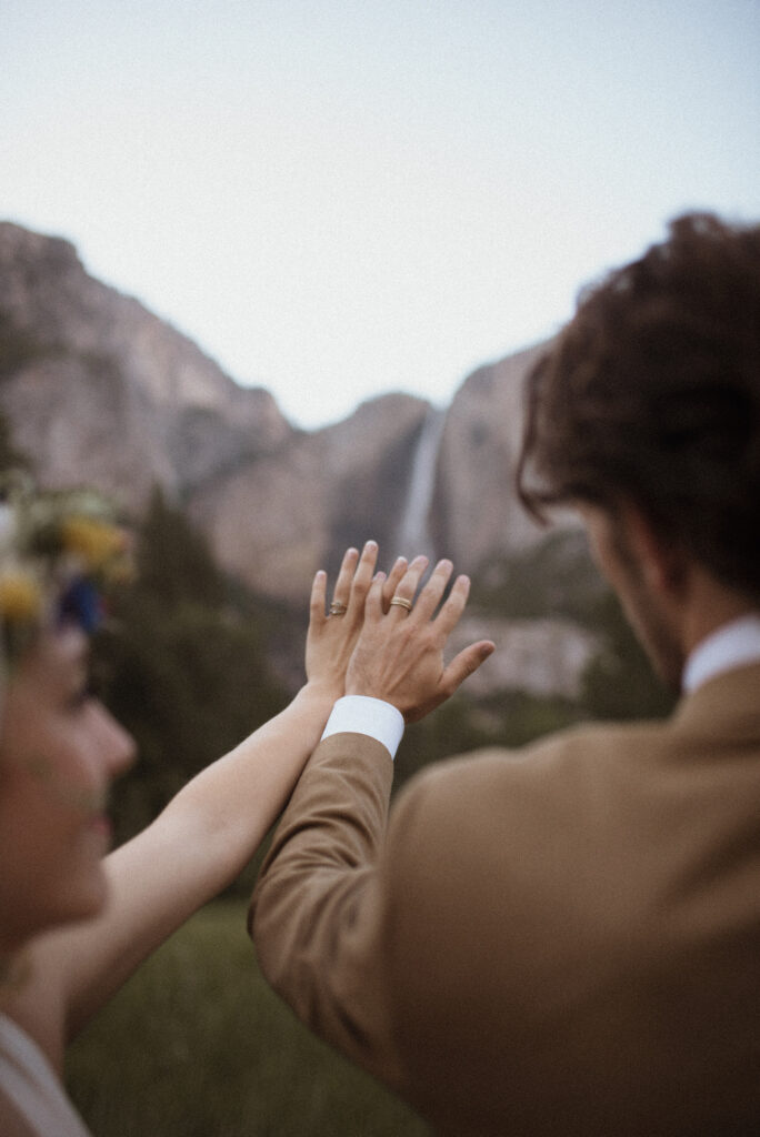 Elopement Photography, bride and groom show off their rings in Yosemite Valley 