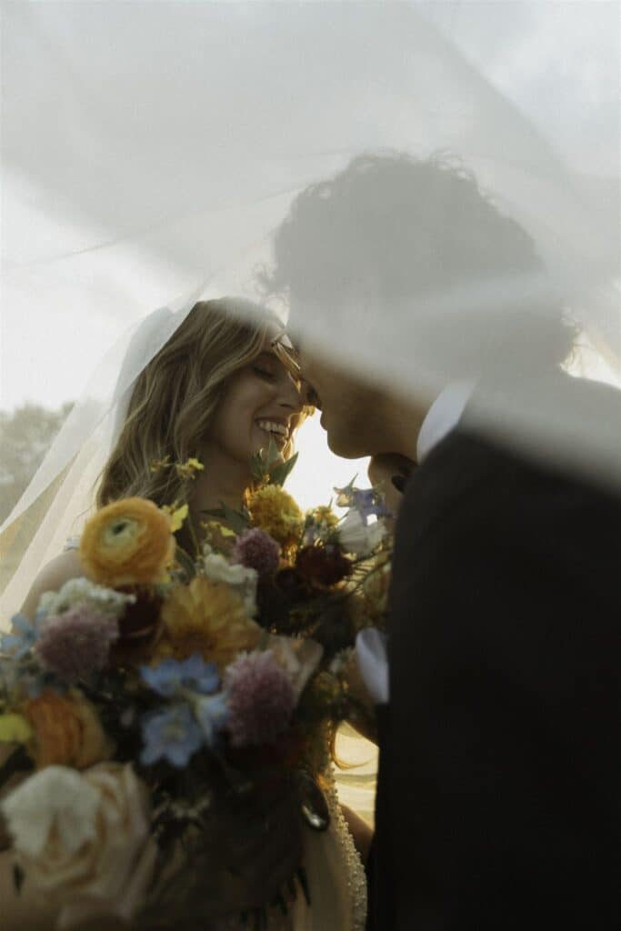 Bride and Groom under the brides veil
