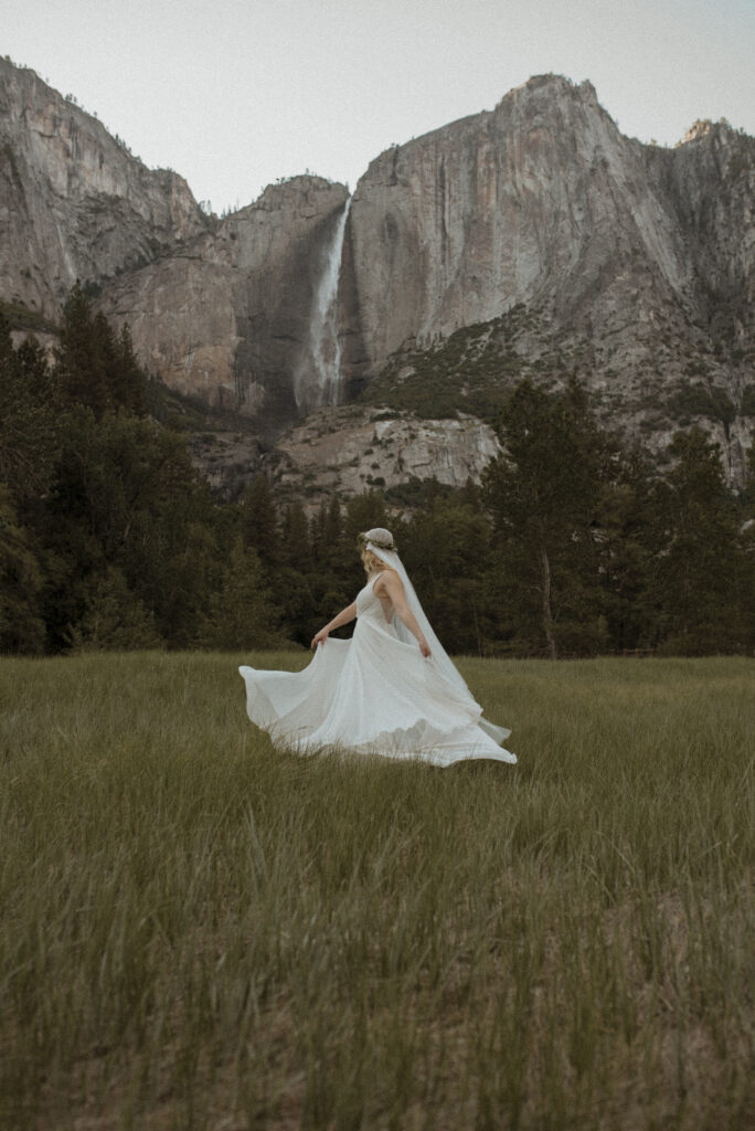 Elopement photography, bride running in the meadow after her ceremony